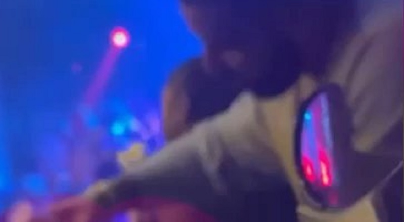 Drake takes liquor from the bartender and makes his own drink