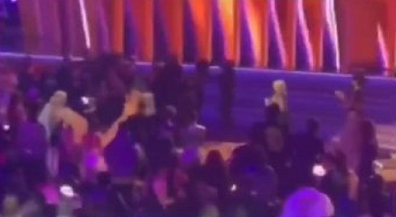 Doja Cat runs from the bathroom to accept her Grammy on stage